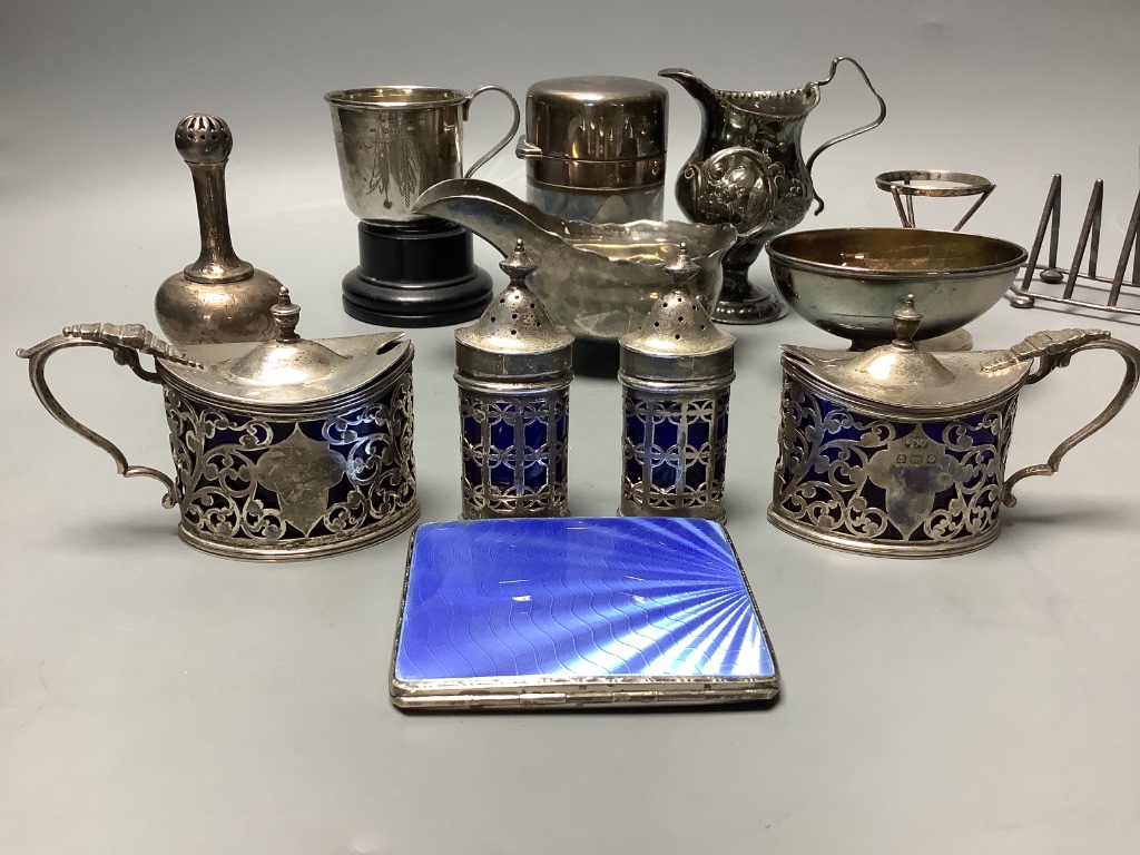 A group of 18th century and later silver, including a George III Newcastle sauceboat, by John Langlands and cream jug, later condiment set, Victorian toastrack, trophy, salts bottle, salt, rosewater sprinkler etc. some a